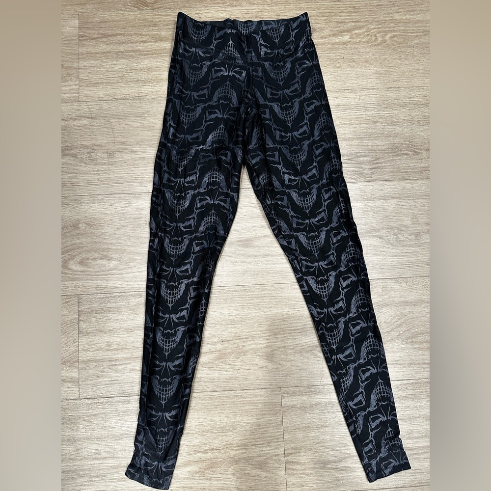 BlackMilk black smiling demon face on black leggings, small.